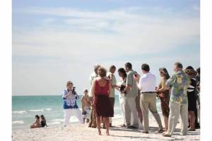 Watching a wedding taking place at the beach
